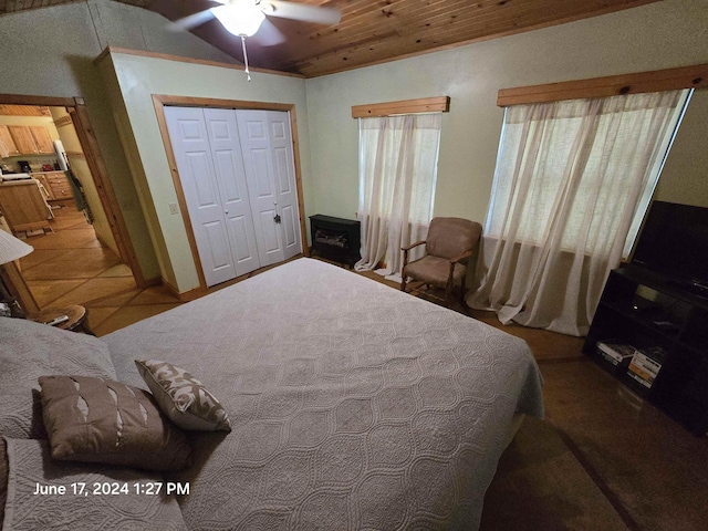 bedroom with tile patterned flooring, wooden ceiling, a closet, and ceiling fan