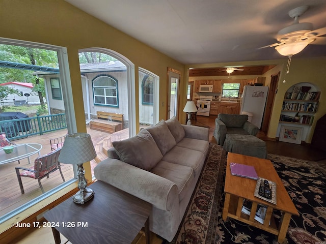 living room featuring plenty of natural light and ceiling fan