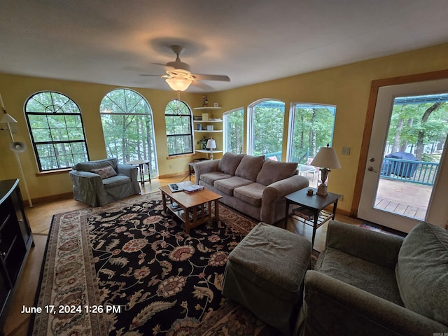 living room featuring ceiling fan and plenty of natural light