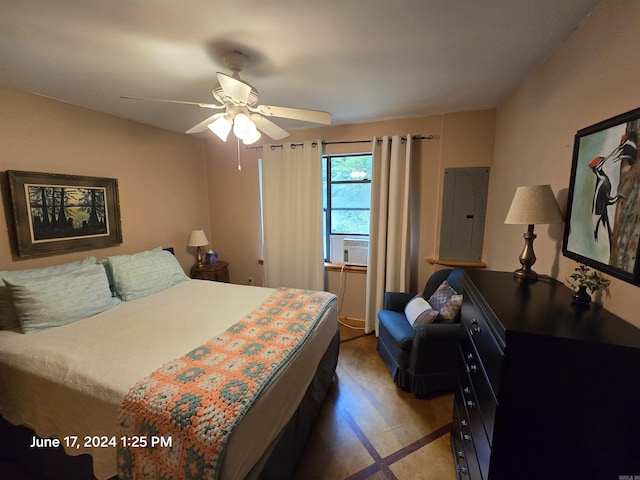 bedroom featuring cooling unit, ceiling fan, electric panel, and hardwood / wood-style floors