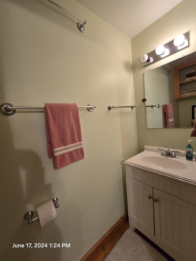 bathroom with vanity and wood-type flooring