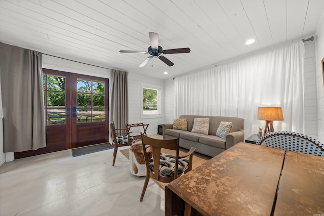 living room featuring light hardwood / wood-style floors, french doors, and ceiling fan