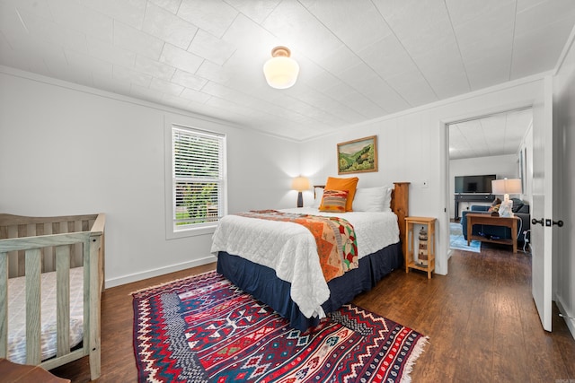 bedroom with dark wood-type flooring