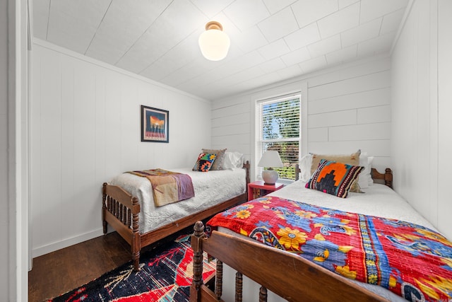 bedroom with ornamental molding and wood-type flooring