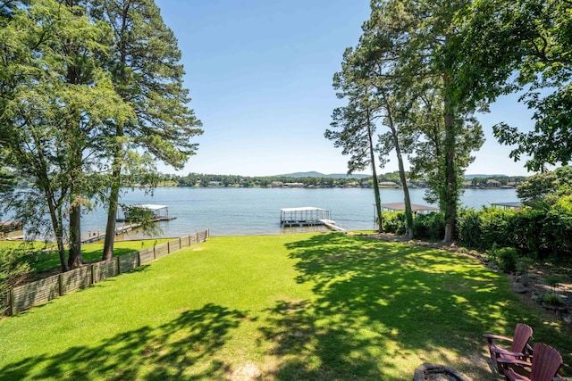 view of yard with a boat dock and a water view