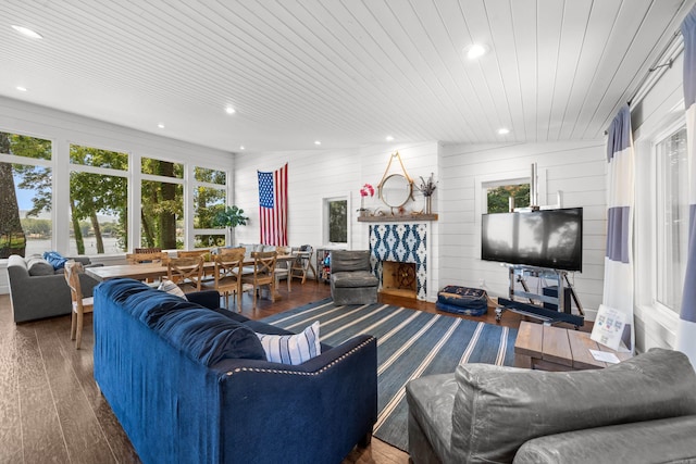 living room featuring wood walls, dark hardwood / wood-style floors, and wood ceiling