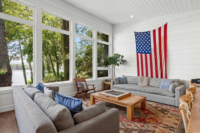 sunroom featuring a wealth of natural light and a water view