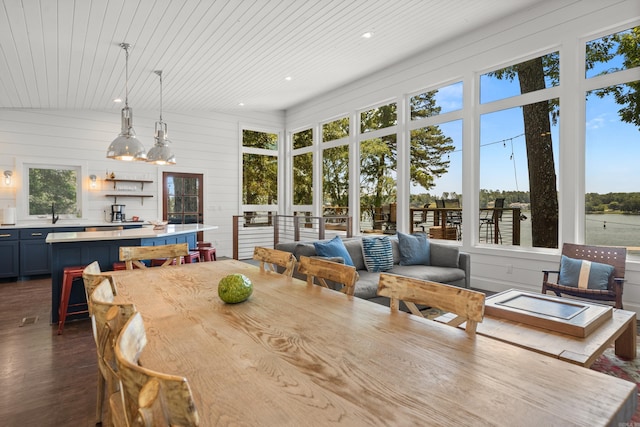 dining space with a wealth of natural light and dark hardwood / wood-style flooring