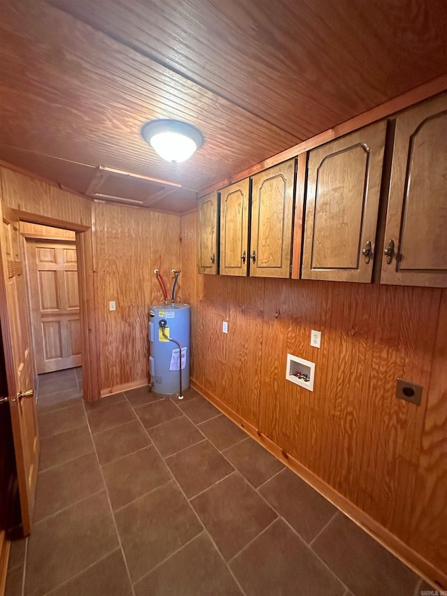 clothes washing area with cabinets, hookup for an electric dryer, electric water heater, wood walls, and wood ceiling