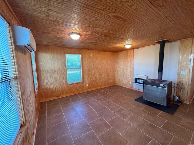 unfurnished living room with wood walls, wooden ceiling, and a wood stove