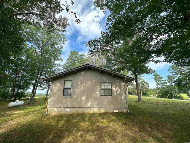 view of side of home featuring a lawn