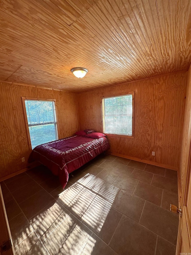 unfurnished bedroom with wood walls and wood ceiling