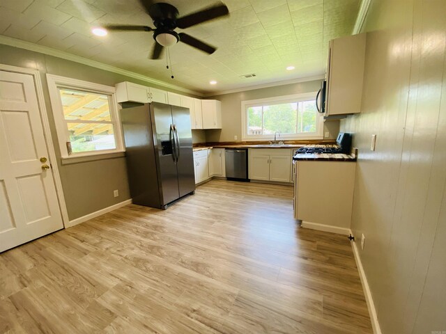 793 Lincoln Dr, Camden, AR 71701 - kitchen with sink, ceiling fan, light wood-type flooring, appliances with stainless steel finishes, and white cabinetry