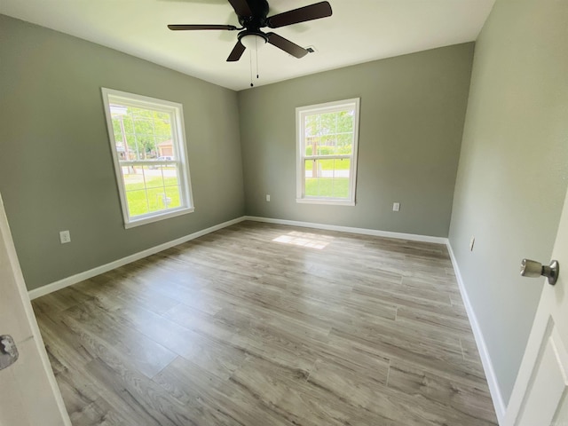 793 Lincoln Dr, Camden, AR 71701 - empty room with ceiling fan, light hardwood / wood-style flooring, and a healthy amount of sunlight