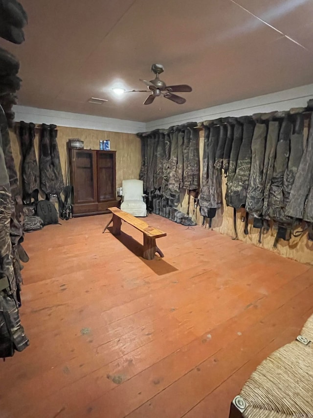 basement with ceiling fan and hardwood / wood-style floors