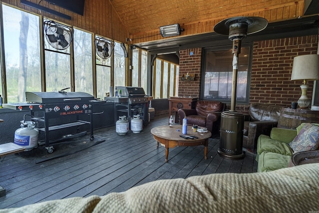 sunroom featuring wooden ceiling and lofted ceiling