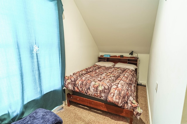 bedroom with lofted ceiling and carpet