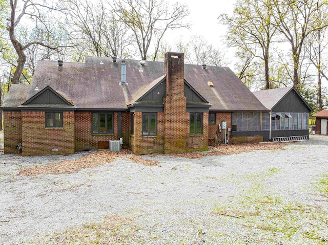 exterior space with a sunroom and central AC unit