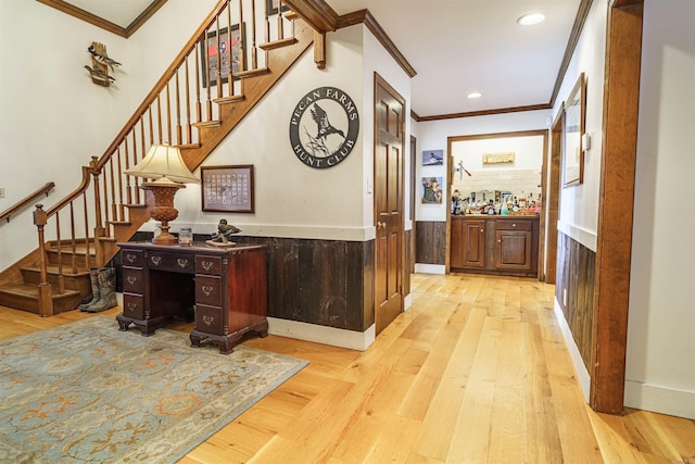 hall with ornamental molding and light wood-type flooring