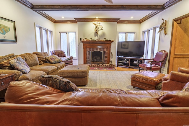 living room featuring beamed ceiling, crown molding, a fireplace, and hardwood / wood-style floors