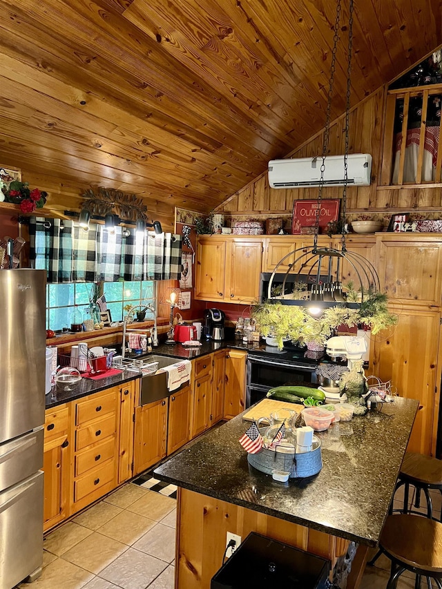 kitchen featuring lofted ceiling, sink, stainless steel refrigerator, and light tile patterned flooring