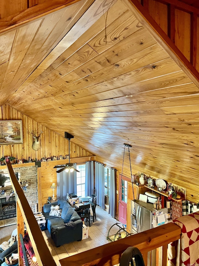 additional living space featuring lofted ceiling, wooden ceiling, and wood walls