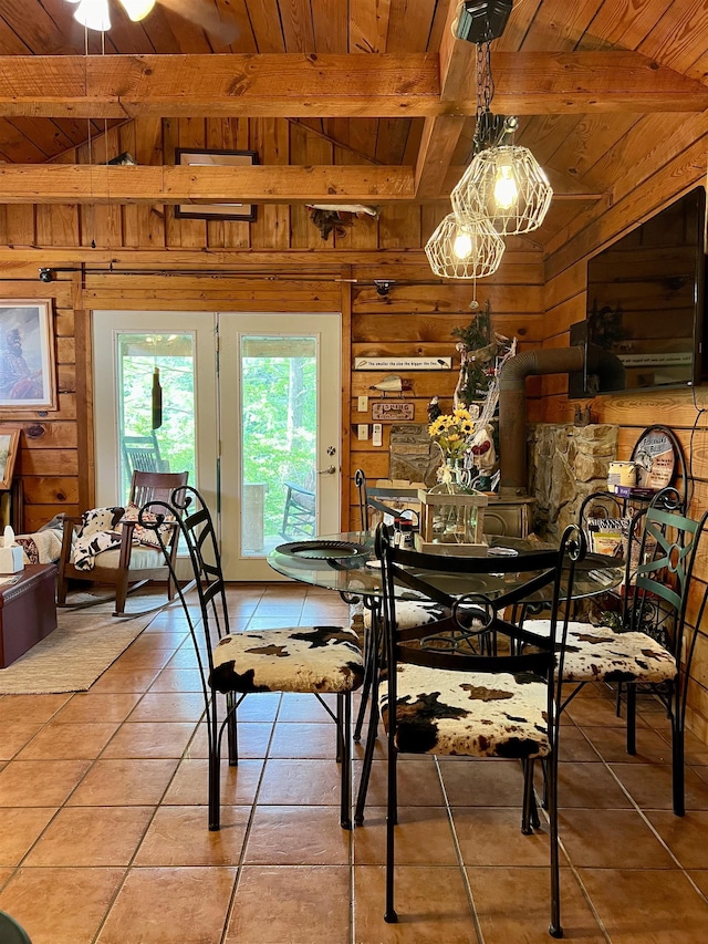 tiled dining room featuring wood ceiling, wooden walls, and lofted ceiling with beams