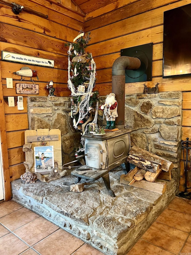 interior details with wood walls and a wood stove