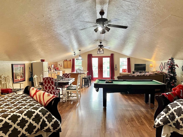 rec room featuring wood-type flooring, lofted ceiling, a textured ceiling, and billiards