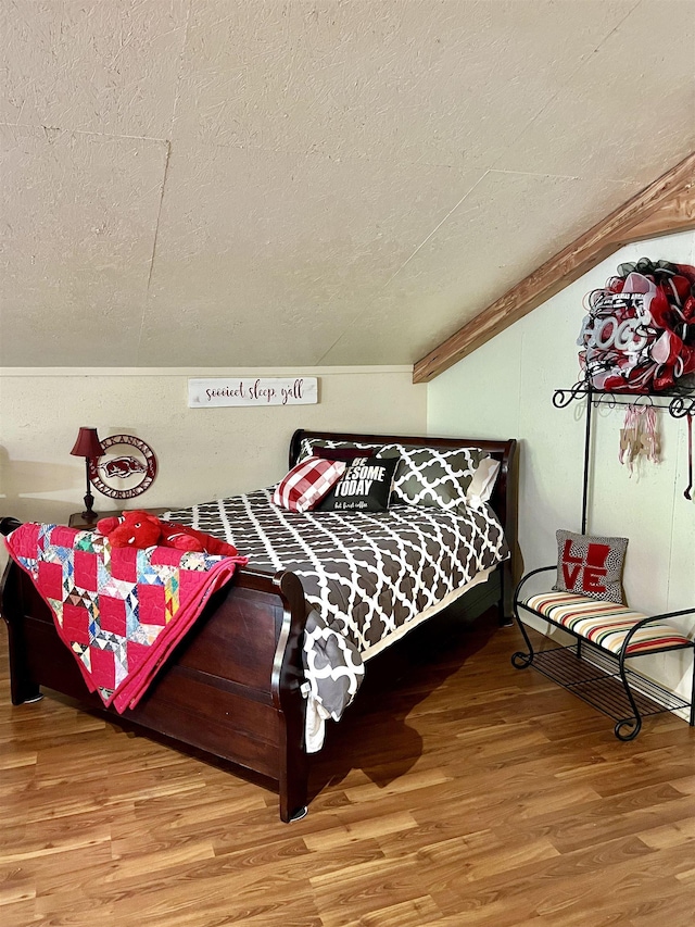 bedroom featuring hardwood / wood-style flooring and a textured ceiling