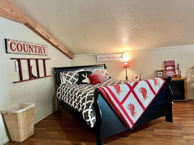 bedroom with lofted ceiling with beams, wood-type flooring, and a textured ceiling