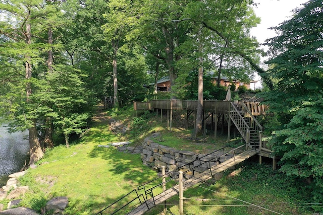 view of yard with a deck with water view