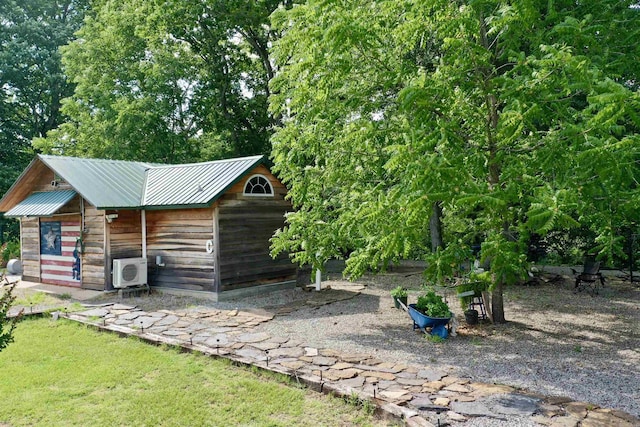 view of yard featuring an outdoor structure and ac unit