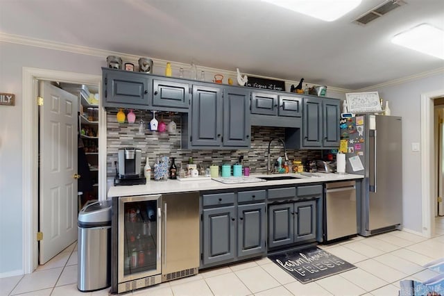kitchen with decorative backsplash, appliances with stainless steel finishes, sink, light tile patterned floors, and wine cooler