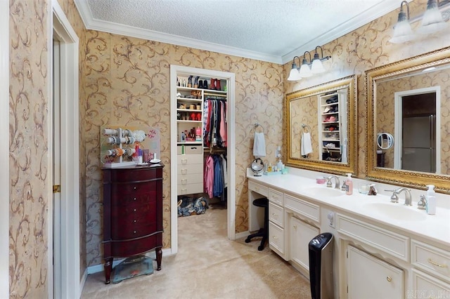 bathroom featuring a textured ceiling, vanity, and ornamental molding