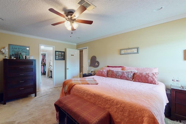 carpeted bedroom with ceiling fan, a textured ceiling, and ornamental molding
