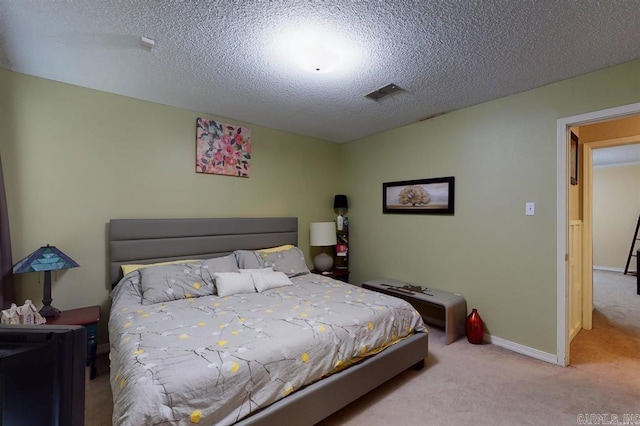 carpeted bedroom featuring a textured ceiling