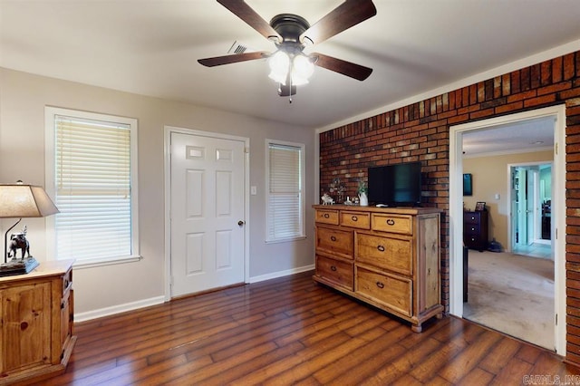 interior space featuring ceiling fan and dark hardwood / wood-style flooring