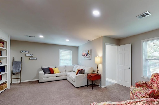 carpeted living room featuring plenty of natural light