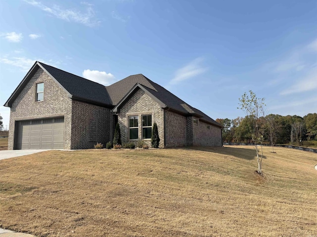 view of front of home with a garage and a front lawn