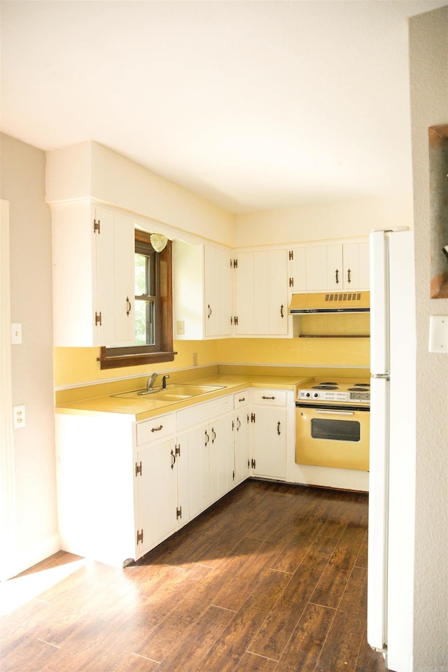 kitchen with custom range hood, white cabinetry, dark wood-type flooring, sink, and white appliances