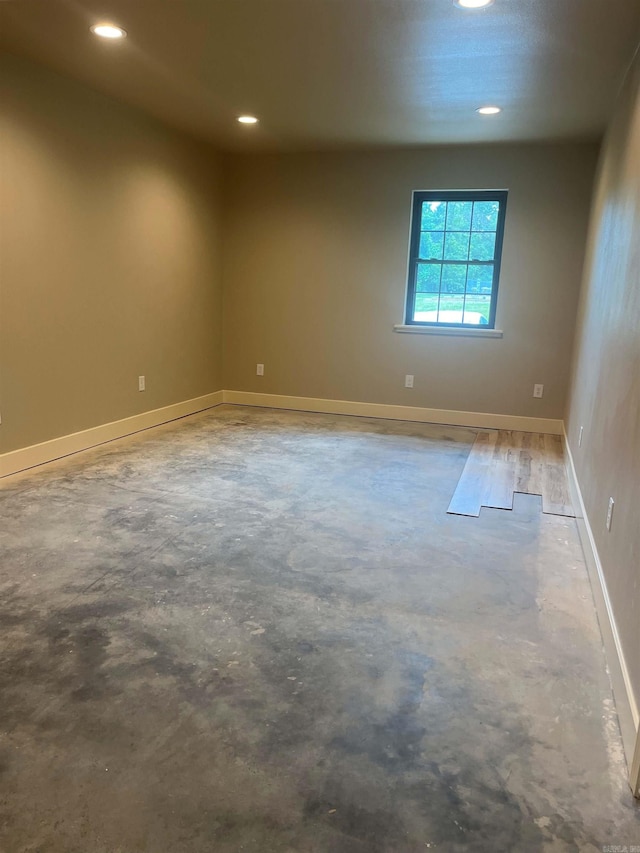 spare room featuring concrete flooring