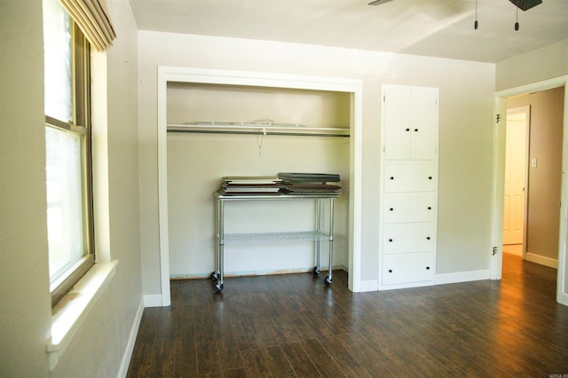 unfurnished bedroom featuring ceiling fan, a closet, and hardwood / wood-style flooring