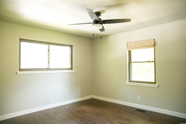 unfurnished room with a healthy amount of sunlight, wood-type flooring, and ceiling fan