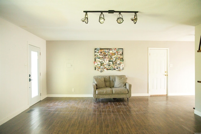 unfurnished room with hardwood / wood-style floors and rail lighting