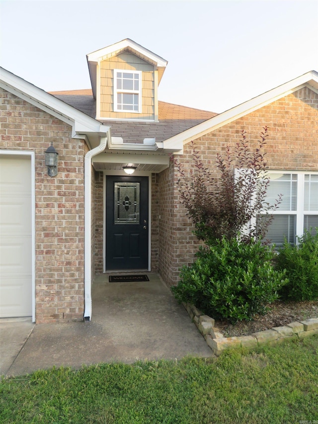 view of exterior entry with a garage