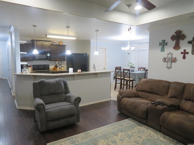 living room featuring ceiling fan with notable chandelier, dark hardwood / wood-style flooring, ornamental molding, and sink