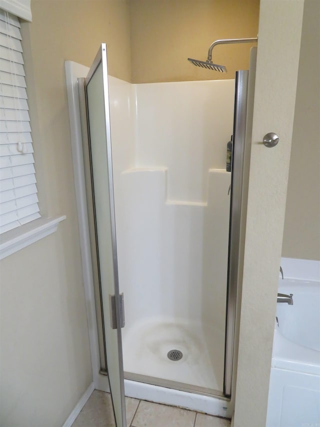 bathroom with tile patterned flooring and independent shower and bath