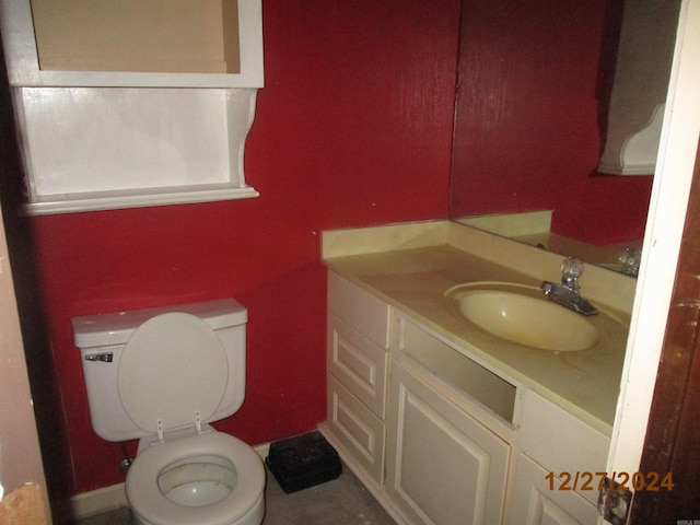 bathroom featuring vanity and toilet