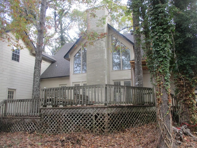 back of house with a wooden deck